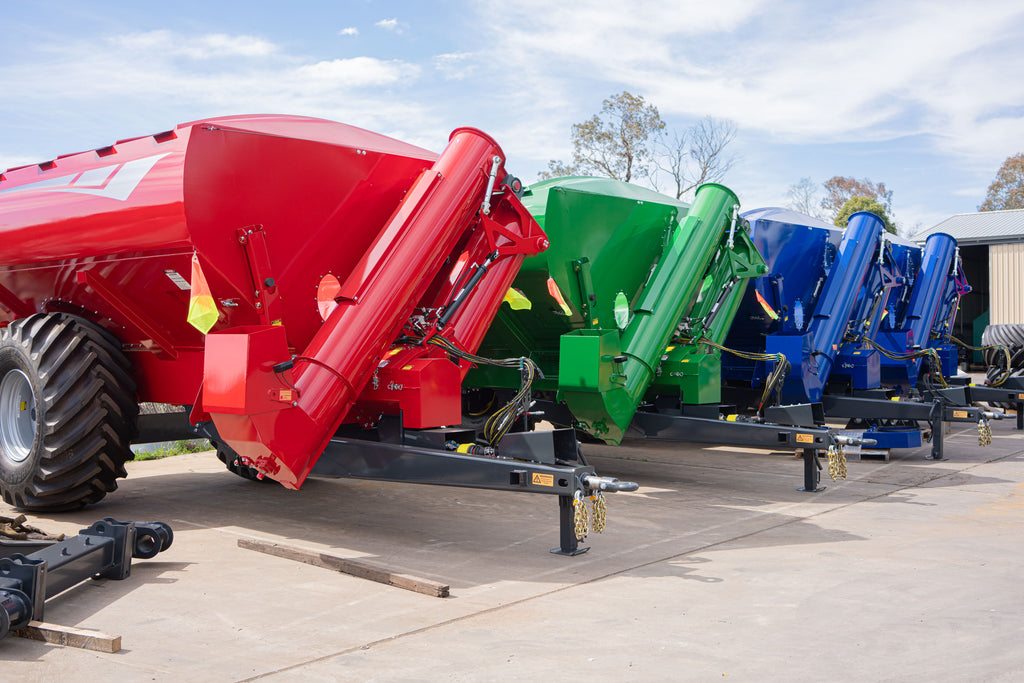 Red, green and blue Davimac chaser bins lined up in factory