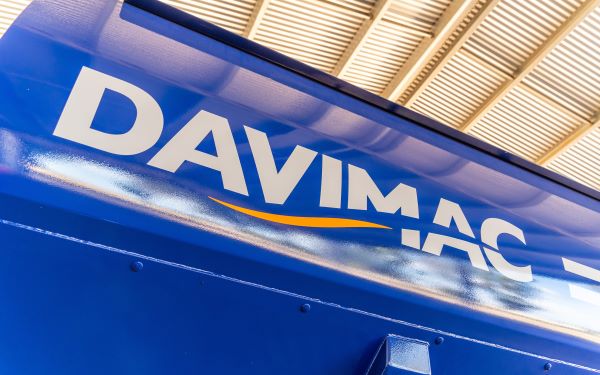 Curved side of a chaser bin with Davimac logo