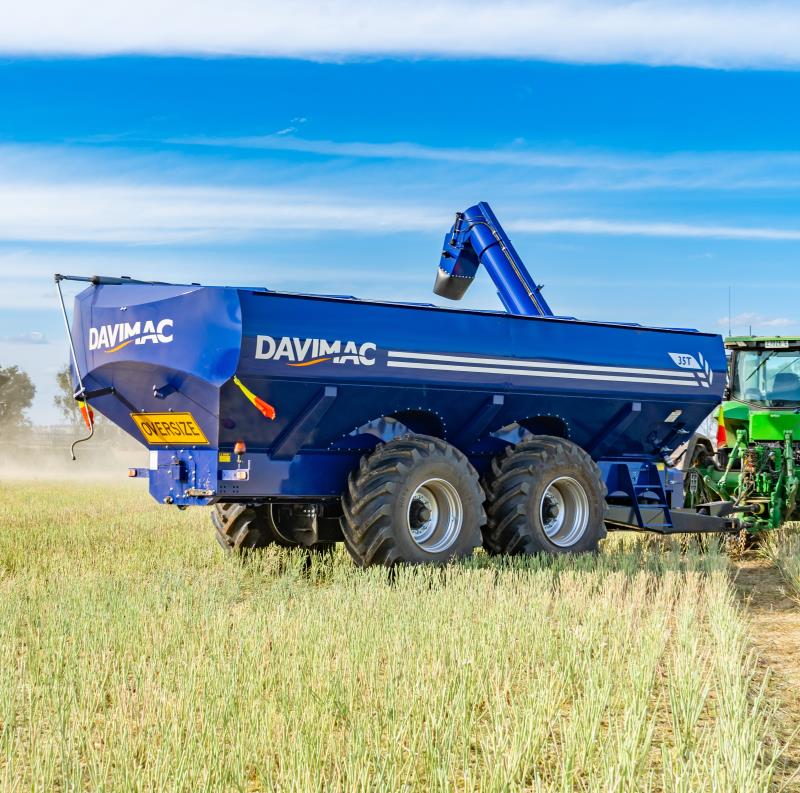 Dual axle Davimac Chaser bin with auger extended in field