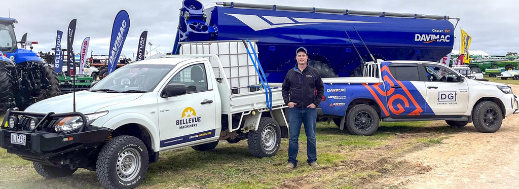 Davimac employees in front of Bellevue and Davimac Group utes in front of Davimac Chaser Bin at Field Day