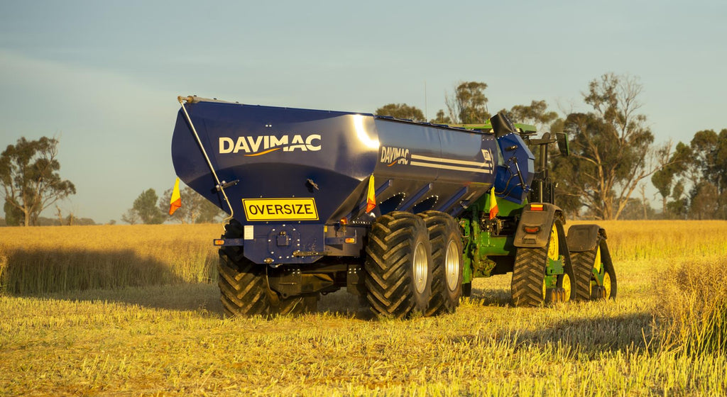 Rear view of Davimac chaser bin in the field with tracked tractor