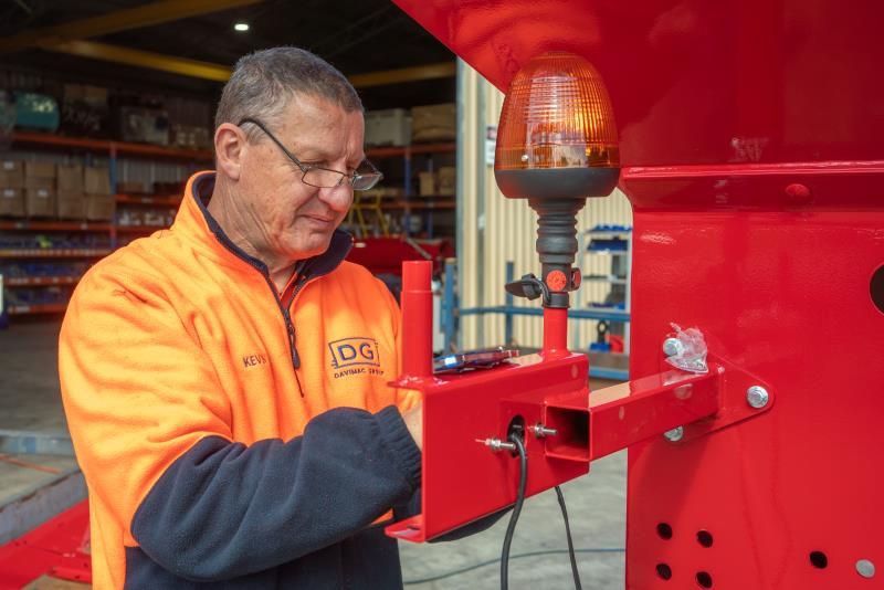 davimac worker installing chaser bin tail light assembly